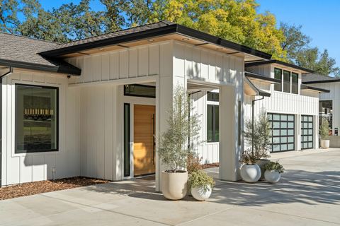 Renovated white home exterior with new windows and entry