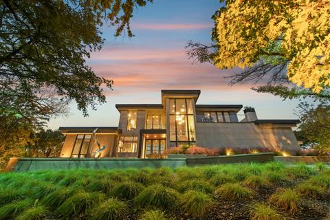 Modern two-story home with large windows at dusk