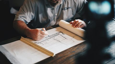 Contractor reviewing a set of construction drawings